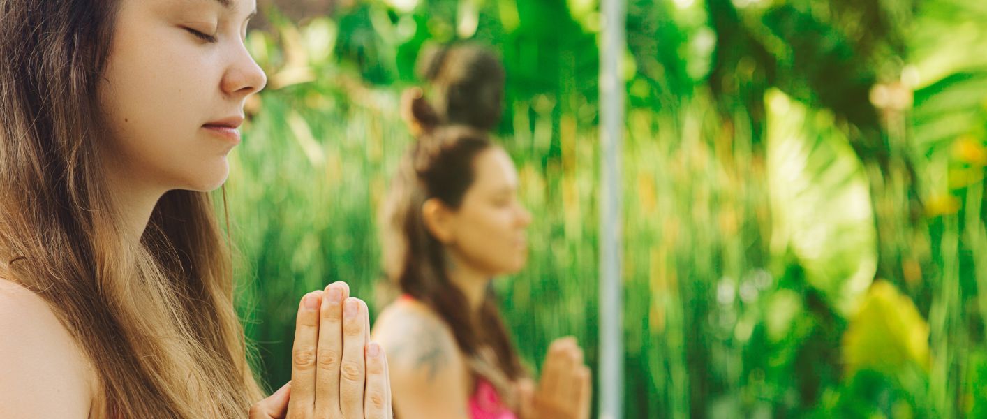 two women doing trauma recovery yoga